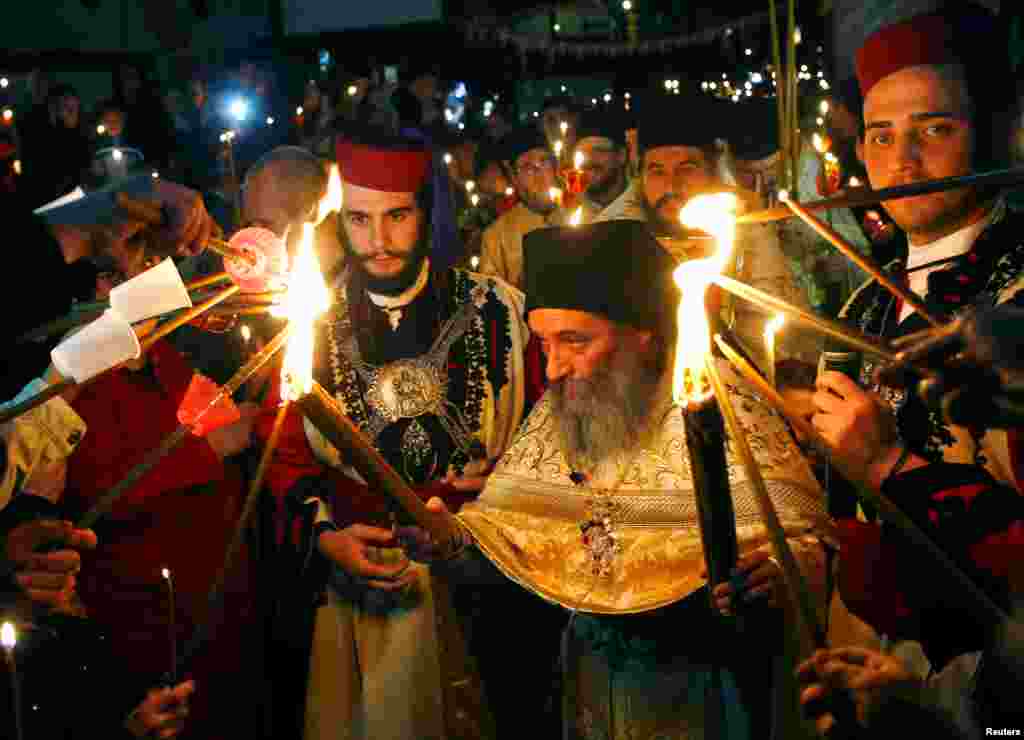 Priests lead the Christian Orthodox Easter service at the 10th century St. John the Baptist Monastery near Mavrovo, west of Macedonia's capital Skopje, April 16, 2017.