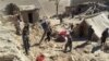 Rescuers have struggled to reach quake-struck zones like this one, where Afghan men remove personal belongings from Takhar province homes, northeast of Kabul, Oct. 27, 2015.