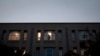 FILE - An employee inside Pakistan's embassy in Washington looks out a window, Nov. 5, 2007.