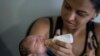 Daniele Ferreira dos Santos feeds her son Juan Pedro, who suffers from microcephaly, as they wait to be examined at the Altino Ventura Foundation, a treatment center that provides free health care, in Recife, Pernambuco state, Brazil, Feb. 4, 2016. 