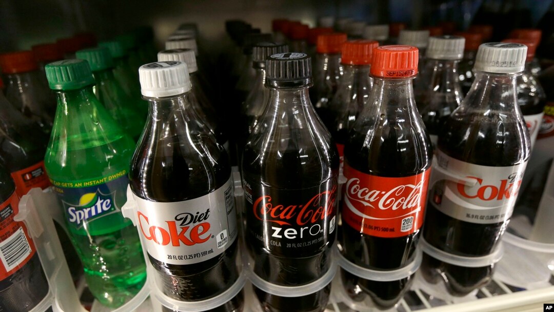 FILE - This Wednesday, Oct. 1, 2014, file photo, shows soft drinks for sale at K & D Market in San Francisco. Recently, Baltimore, Maryland, became the largest city in the United States to ban restaurants from including sodas and other sugary drinks on their menus for children.