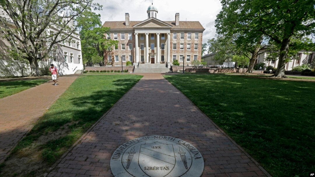 FILE - A sidewalk leads to the South Building on campus at The University of North Carolina in Chapel Hill, N.C., April 20, 2015. 