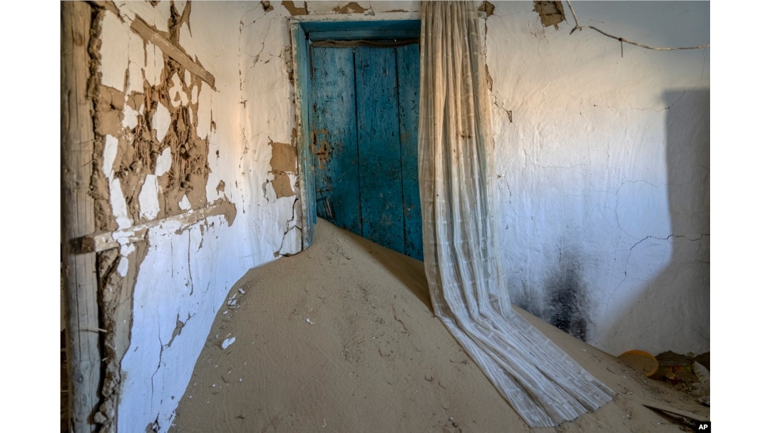A house decimated by sandstorms sits in the destroyed village on the edge of the dried-up Aral Sea, near Tastubek, Kazakhstan, Monday, July 3, 2023. (AP Photo/Ebrahim Noroozi)