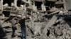 FILE - People stand on the rubble at the site of the Israeli airstrike that killed Lebanon's Hezbollah leader Sayyed Hassan Nasrallah on Friday, in Beirut's southern suburbs, Lebanon, Sept. 29, 2024. 