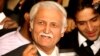 FILE - Farhatullah Babar speaks to the media outside the supreme court building in Islamabad, Dec. 16, 2009.