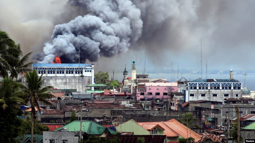 Black smoke comes from a burning building in a commercial area of Osmena street in Marawi city, Philippines June 14, 2017. 