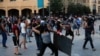 People throw stones during a protest following last week's explosion that killed many and devastated the city, in Beirut, Lebanon, Aug. 11, 2020.