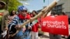 A protester brandishes a wooden stick during a rally in front of the Nigerian embassy in northwest Washington, May 6, 2014, protesting the kidnapping of nearly 300 teenage schoolgirls from a school in the remote northeast of Nigeria three weeks ago.