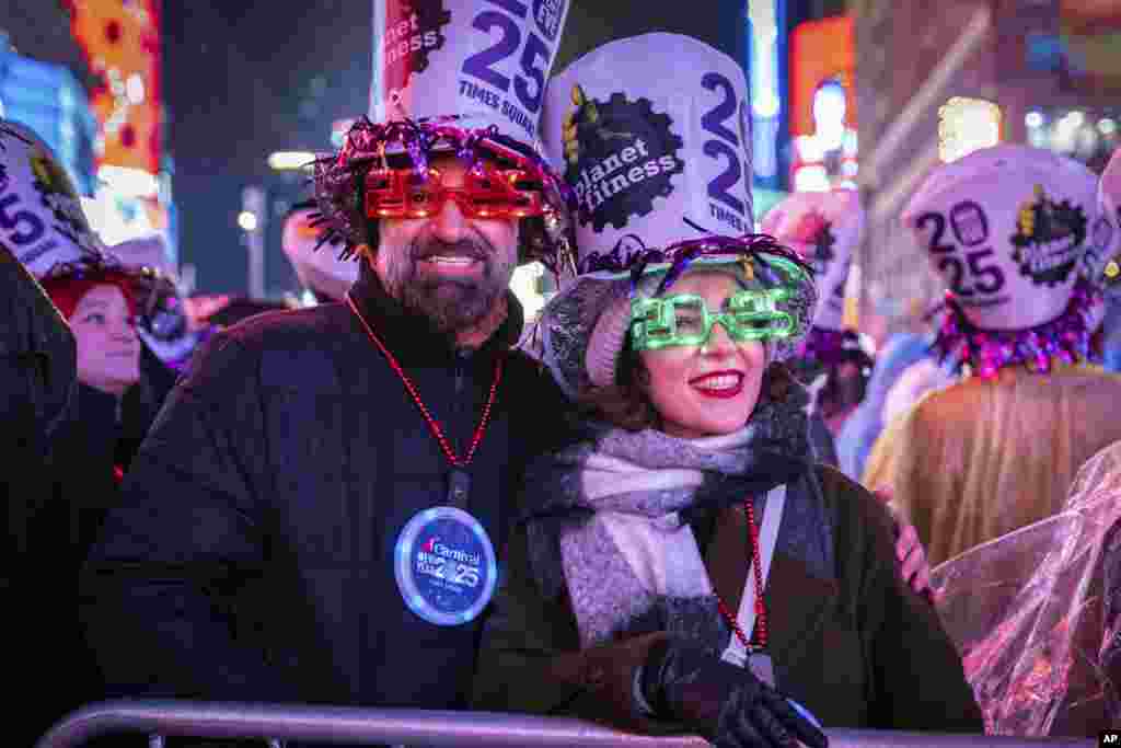 Revelers celebrate in New York's Times Square as they attend a New Year's Eve celebration, Dec. 31, 2024.