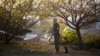 An Afghan policeman gets his prayer rug out while guarding the premises where thousands of prominent Afghans are scheduled to meet for a Loya Jirga, on the outskirts of Kabul, Afghanistan, Nov. 20, 2013.