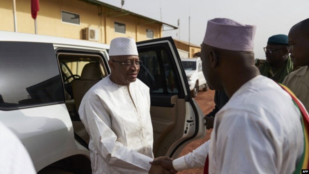 FILE - Malian Prime Minister Soumeylou Boubeye Maiga shakes hand with the Mayor of Mopti during his visit in Mali's central region on Oct. 14, 2018. 