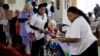 Elderly and disabled South African voters, assisted by nurses, cast their ballots during early voting for special groups at the Nazareth House old-age home in Johannesburg, South Africa, May 5, 2014.