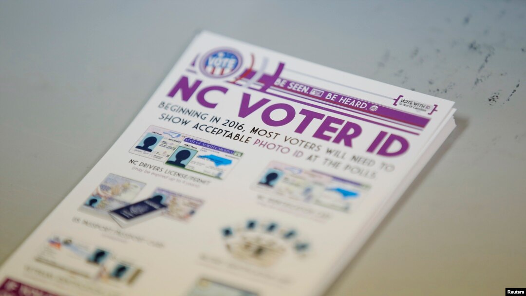 FILE - Government pamphlets explaining North Carolina's voter identification law sit on table at a polling station in Charlotte, July 15, 2016.