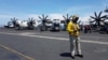An air traffic controller guides aircraft landing on the deck of the USS Theodore Roosevelt, transiting the South China Sea April 10, 2018. 