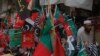 Flags of political parties are on sale ahead of elections, in Peshawar, Pakistan, Friday, July 20, 2018. 