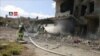 FILE - Firefighters respond at the destroyed Nabd Al-Hayat hospital that was hit by an airstrike in Hass, Idlib province, Syria, May 6, 2019, in this still image taken from a video on May 9, 2019. 