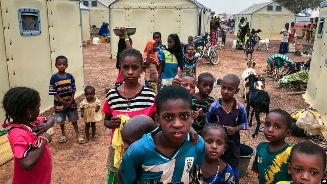 FILE - Children displaced by attacks gather in a makeshift camp for the displaced in Youba, Yatenga province, Burkina Faso, April 20, 2020.