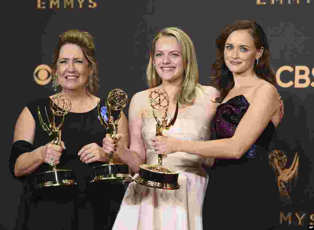 Ann Dowd, from left, winner of outstanding supporting actress in a drama series, Elisabeth Moss, winner of outstanding lead actress in a drama series, and Alexis Bledel, winner of outstanding guest actress in a drama for &quot;The Handmaid&#39;s Tale&quot; pose at the 69th Primetime Emmy Awards, Sept. 17, 2017, at the Microsoft Theater in Los Angeles.