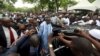 Nigeria's President Muhammadu Buhari (C) is shielded by security after prayers at the Abuja praying ground on the first day of the Muslim holiday of Eid-al-Fitr, marking the end of the holy month of Ramadan in Abuja, Nigeria's capital, July 17, 2015. 