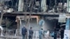 Afghan policemen inspect the site of a bomb attack in Kabul, Afghanistan, Jan.28, 2018. 