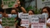 Health workers wearing protective masks protest in front of a government hospital in Manila, Feb. 7, 2020. The Philippines, Feb. 2, reported the first death from the new coronavirus outside mainland China.
