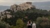 People visit the Pnyx Hill in Athens overlooking the ancient Acropolis on May 29, 2020 as Greece eases lockdown measures taken to curb the spread of COVID-19. ​