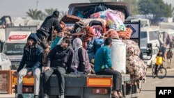A truck carrying people fleeing from the central Gaza Strip with their belongings arrives in Rafah in the southern Gaza Strip following an evacuation order on December 26, 2023, amid the ongoing conflict between Israel and the Palestinian militant group H