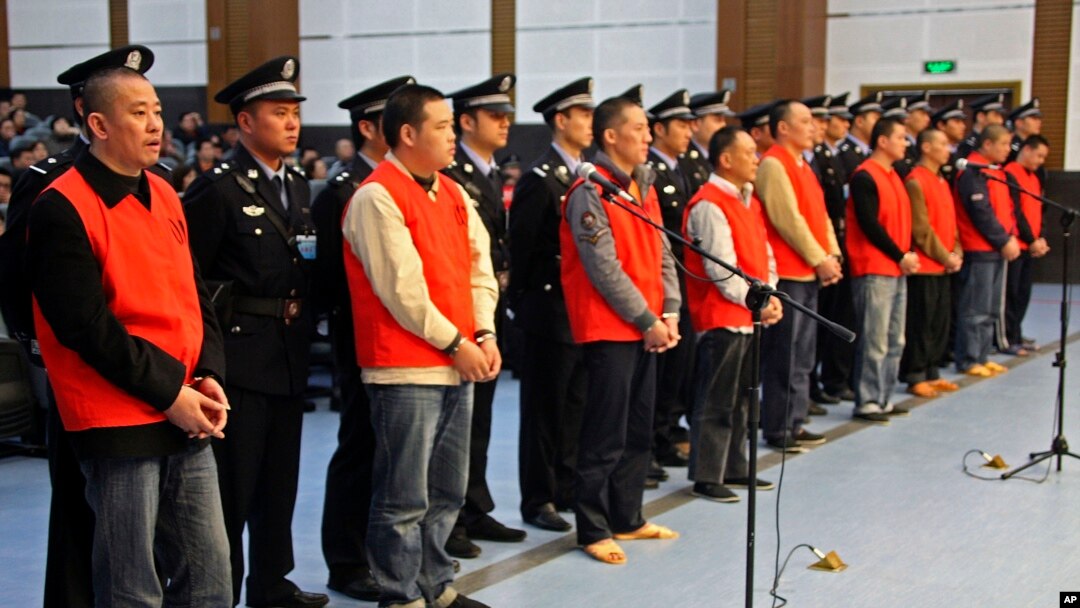 In this photo taken Oct. 12, 2009, Yang Tianqing, first left, and other unidentified suspects allegedly ivolved in mafia-style gangs stand trial at the Chongqing No.1 Intermediate People's Court in Chongqing, China. 