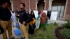 Pakistani election workers carry polling material after collecting it from an election office in Rawalpindi, Pakistan, May 10, 2013. 