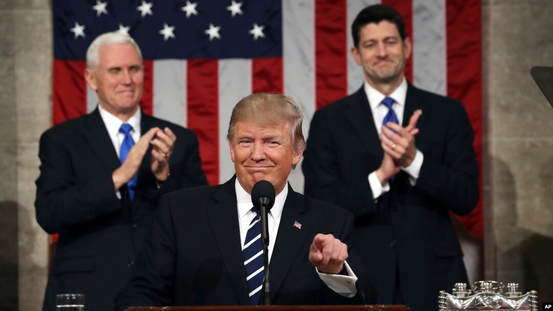 U.S. President Donald Trump, flanked by Vice President Mike Pence and House Speaker Paul Ryan of Wisconsin, gestures on Capitol Hill in Washington before his address to a joint session of Congress, Feb. 28, 2017.