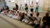 Worshippers listen as Imam Syed Shafeeq Rahman of the Islamic Center of Fort Pierce offers a prayer for victims of the Orlando shooting, in Fort Pierce, Florida, June 12, 2016.