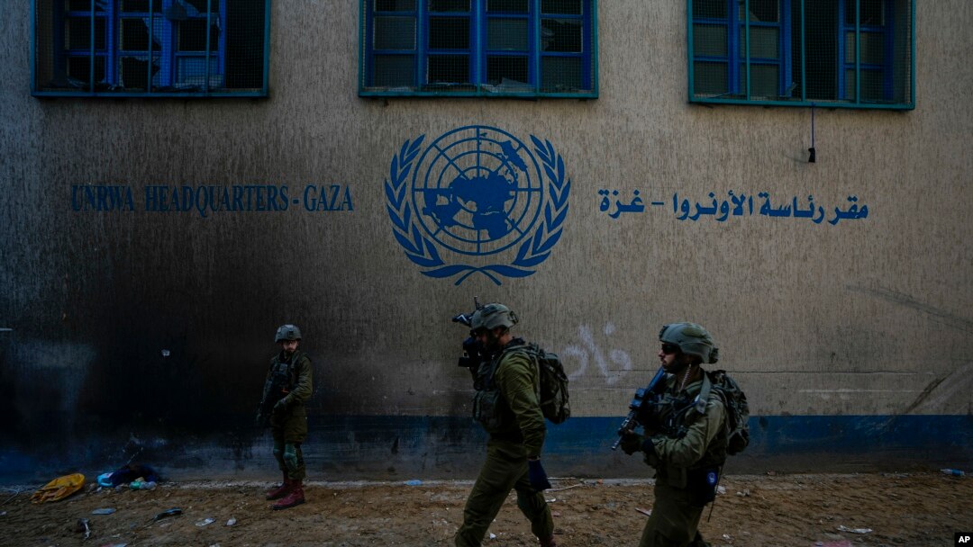 FILE - Israeli soldiers take position as they enter the UNRWA headquarter during a ground operation in Gaza, Thursday, Feb. 8, 2024.