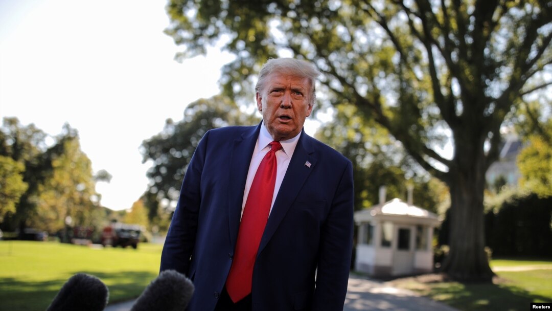 FILE - U.S. President Donald Trump talks to reporters as he departs for campaign travel to Ohio from the South Lawn at the White House in Washington, Sept. 21, 2020.