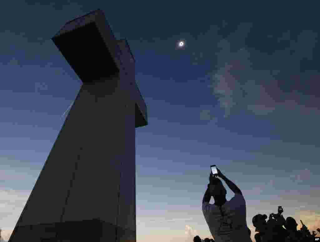 A total solar eclipse is seen above the Bald Knob Cross of Peace, Aug. 21, 2017, in Alto Pass, Ilinois. 