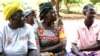 Four women in Uganda sitting on the ground. The women are part of a treatment group for Obstetric Fistula.