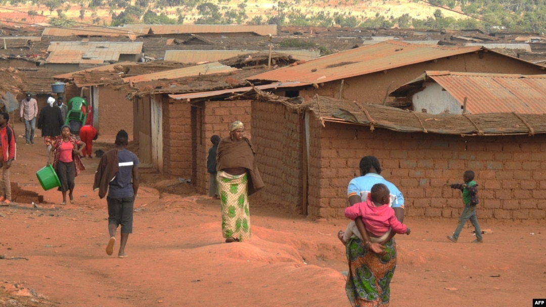 FILE - Refugees of various nationalities walk through Dzaleka refugee camp, Dowa district, in Malawi's Central region, June 20, 2018.