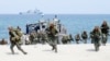 FILE - Philippine and U.S. Marines storm a beach as part of an amphibious landing exercise, May 9, 2018, during a two-week joint U.S.-Philippines exercise facing the South China Sea in the Philippines. 