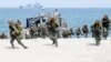 FILE - In this May 9, 2018 photo, Philippine and U.S. Marines storm a beach as part of an amphibious landing exercise during a two-week joint U.S.-Philippines exercise facing the South China Sea in the Philippines. 
