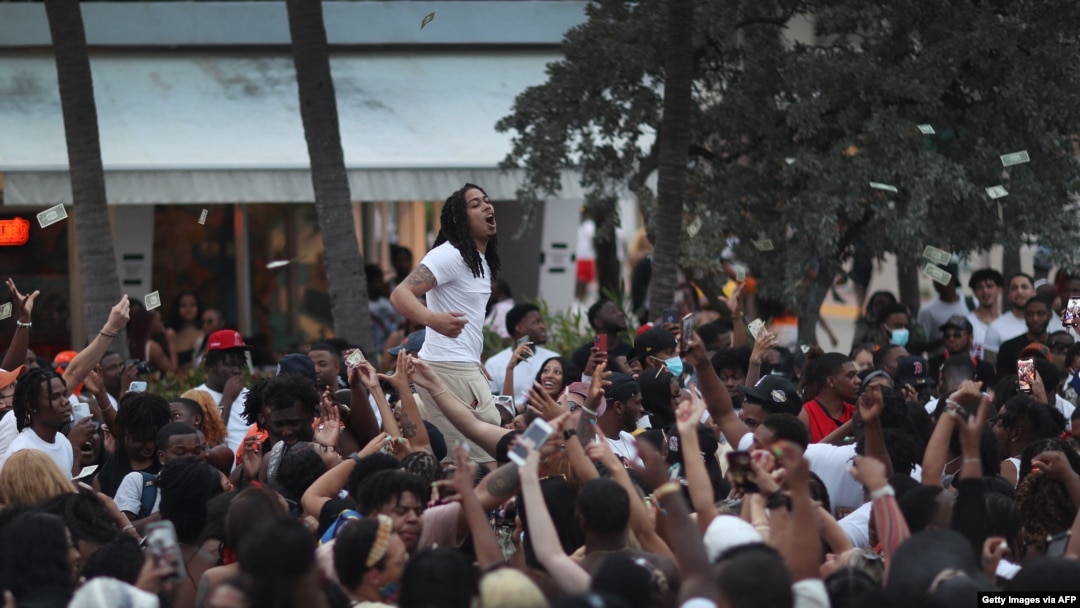 People enjoy themselves along Ocean Drive on March 19, 2021, in Miami Beach, Florida.
