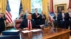 President Donald Trump wraps up a phone call with the leaders of Sudan and Israel, as Cabinet officials and advisers applaud, in the Oval Office of the White House, Oct. 23, 2020, in Washington.