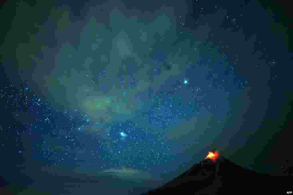 This timed-exposure photo shows Moung Sinabung volcano spewing lava that lights up the night sky in Karo, North Sumatra.