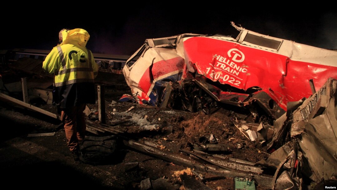 A man walks at the site of a crash, where two trains collided, near the city of Larissa, Greece, March 1, 2023.