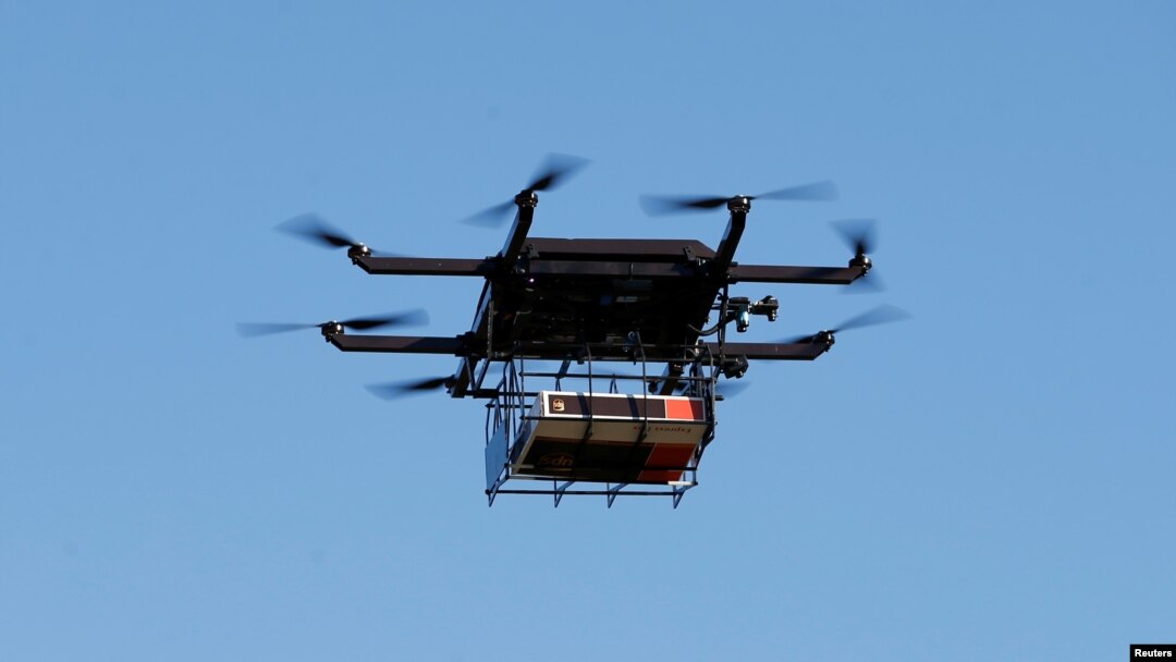 FILE - A drone demonstrates delivery capabilities from the top of a UPS truck during testing in Lithia, Florida, U.S.