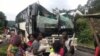 A bus attacked by armed separatist and its passengers are seen at Akum, a village 10 Kilometers from Bamenda, the capital of the Cameroon's English speaking northwest region, Sept. 9, 2018.