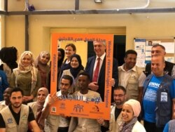 U.N. refugee chief Filippo Grandi poses with refugee volunteers at al-Nuzah Community Support Center in Amman, Jordan, June 20, 2019.