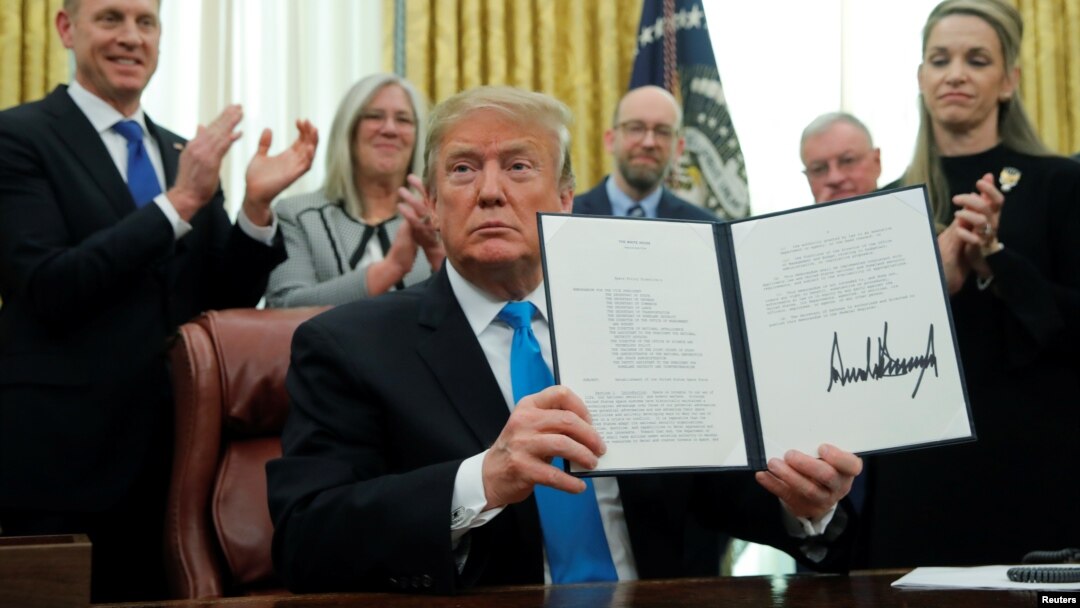 U.S. President Donald Trump displays the "Space Policy Directive 4" after signing the directive to establish a Space Force as the sixth branch of the Armed Forces in the Oval Office at the White House in Washington, Feb. 19, 2019. 